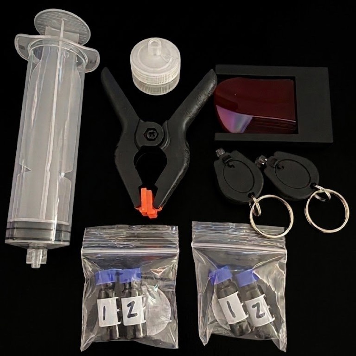 What's inside The Water Test Kit — Nile Red, filters, blue LED, syringe, instructions